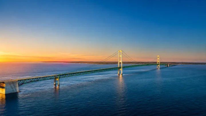 Mackinac Bridge over the water at sunset
